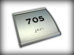 Tactile & Braille room number sign in convex aluminum holder